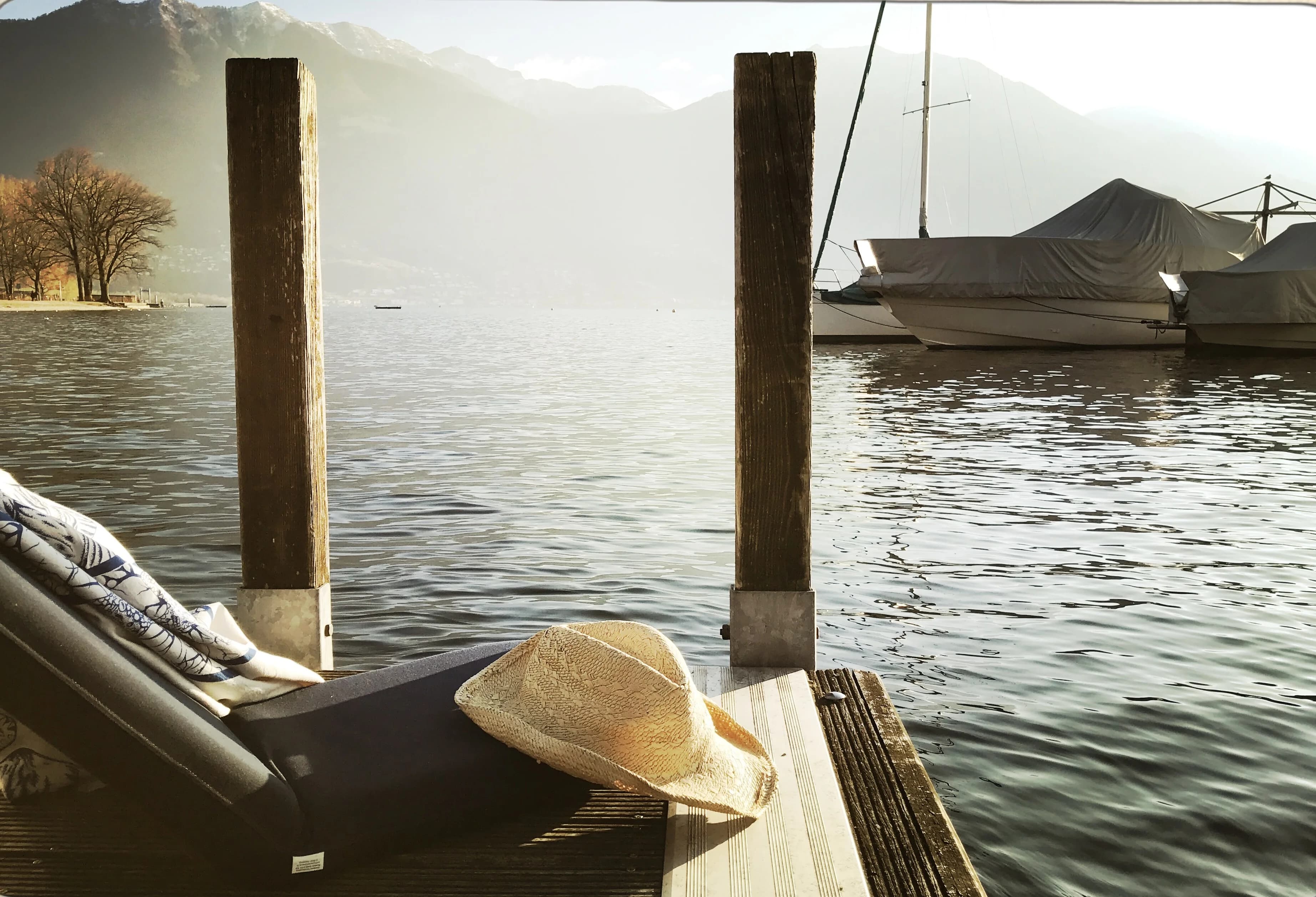 Lounge chair on the dock by calm water