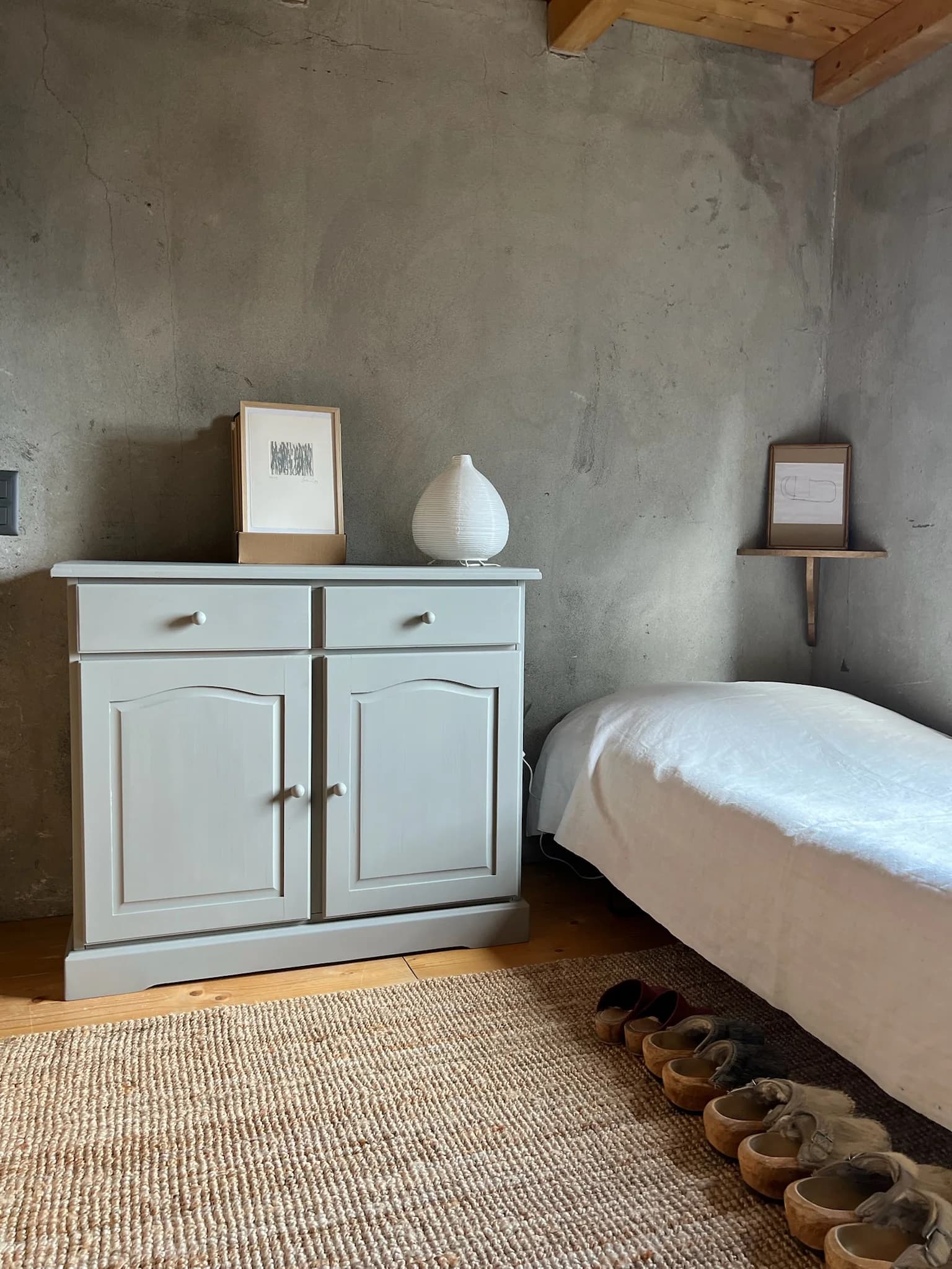 Bedroom with pale cabinet and woven rug
