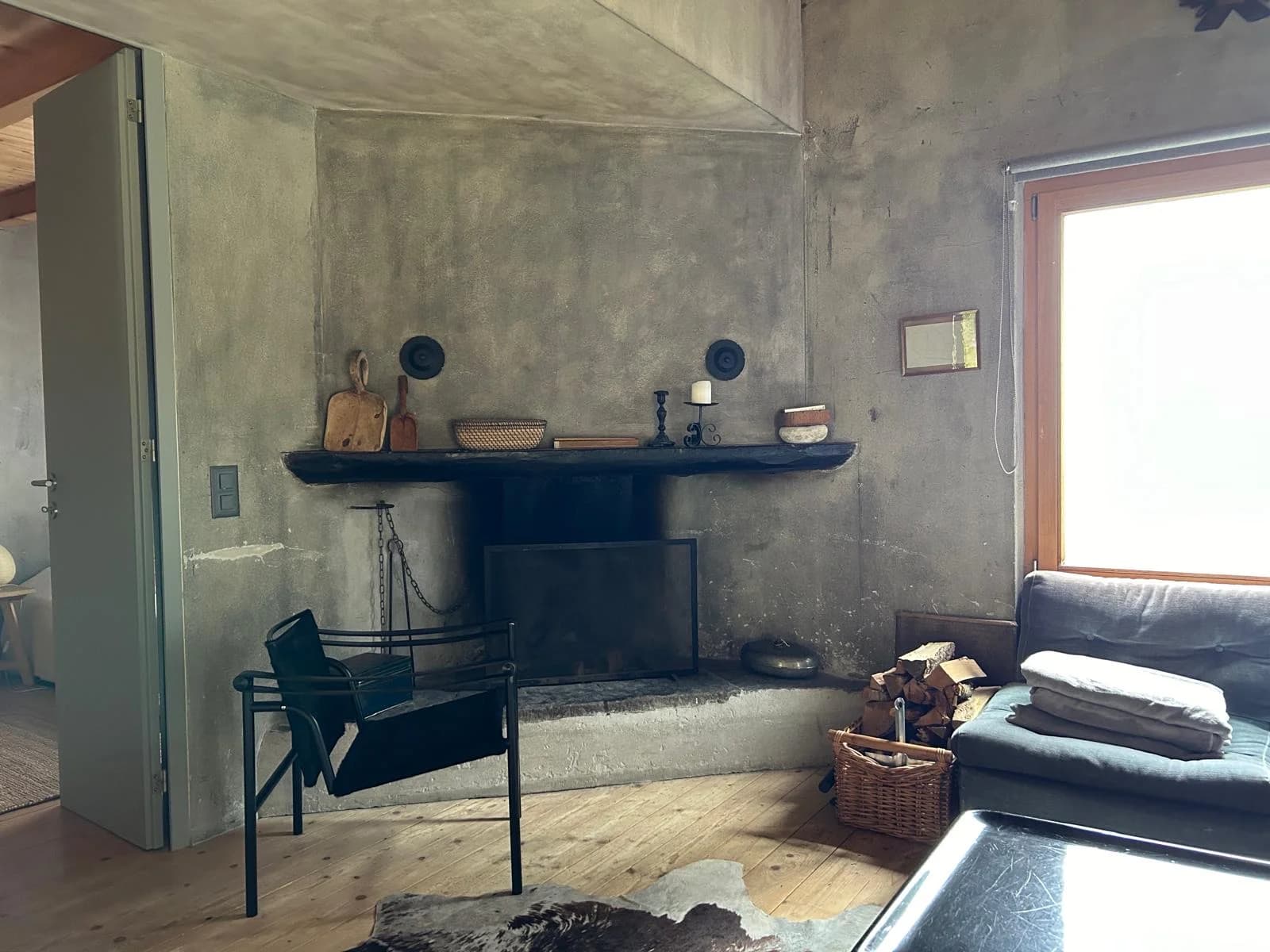 Living room with fireplace, chaise, and timber floor