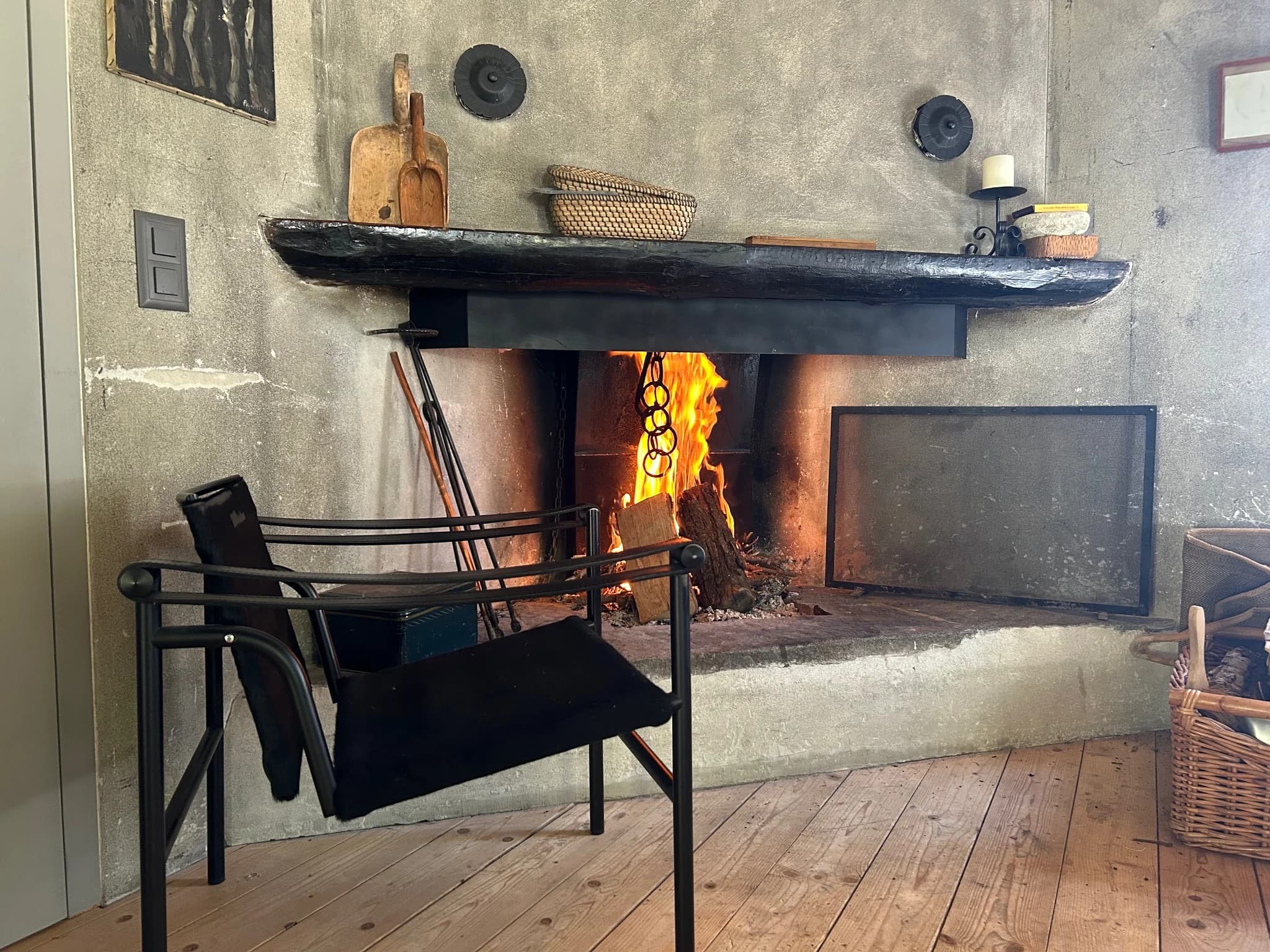Living room fireplace with black lounge chair