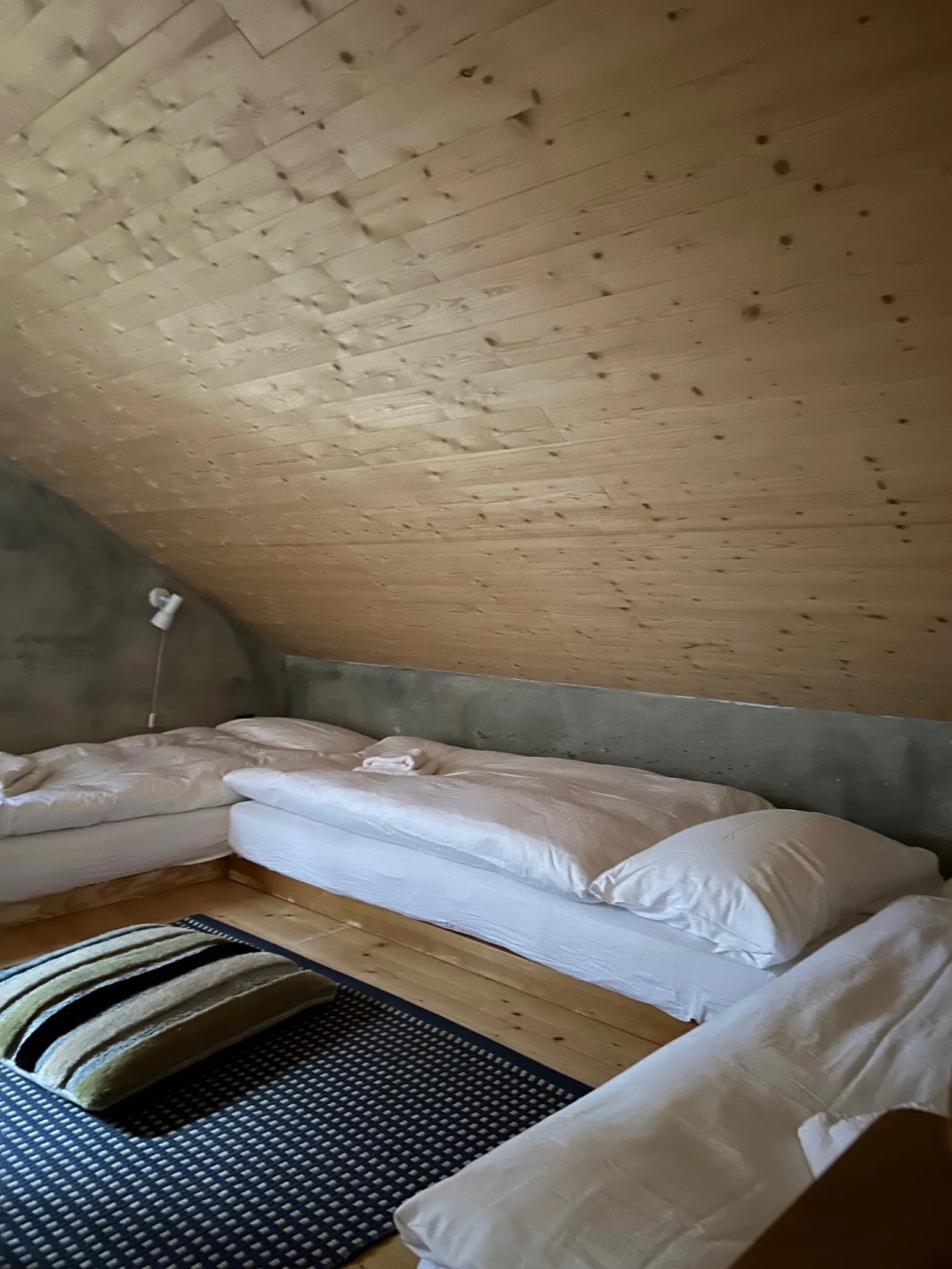 Twin sleeping nook beneath the timber ceiling