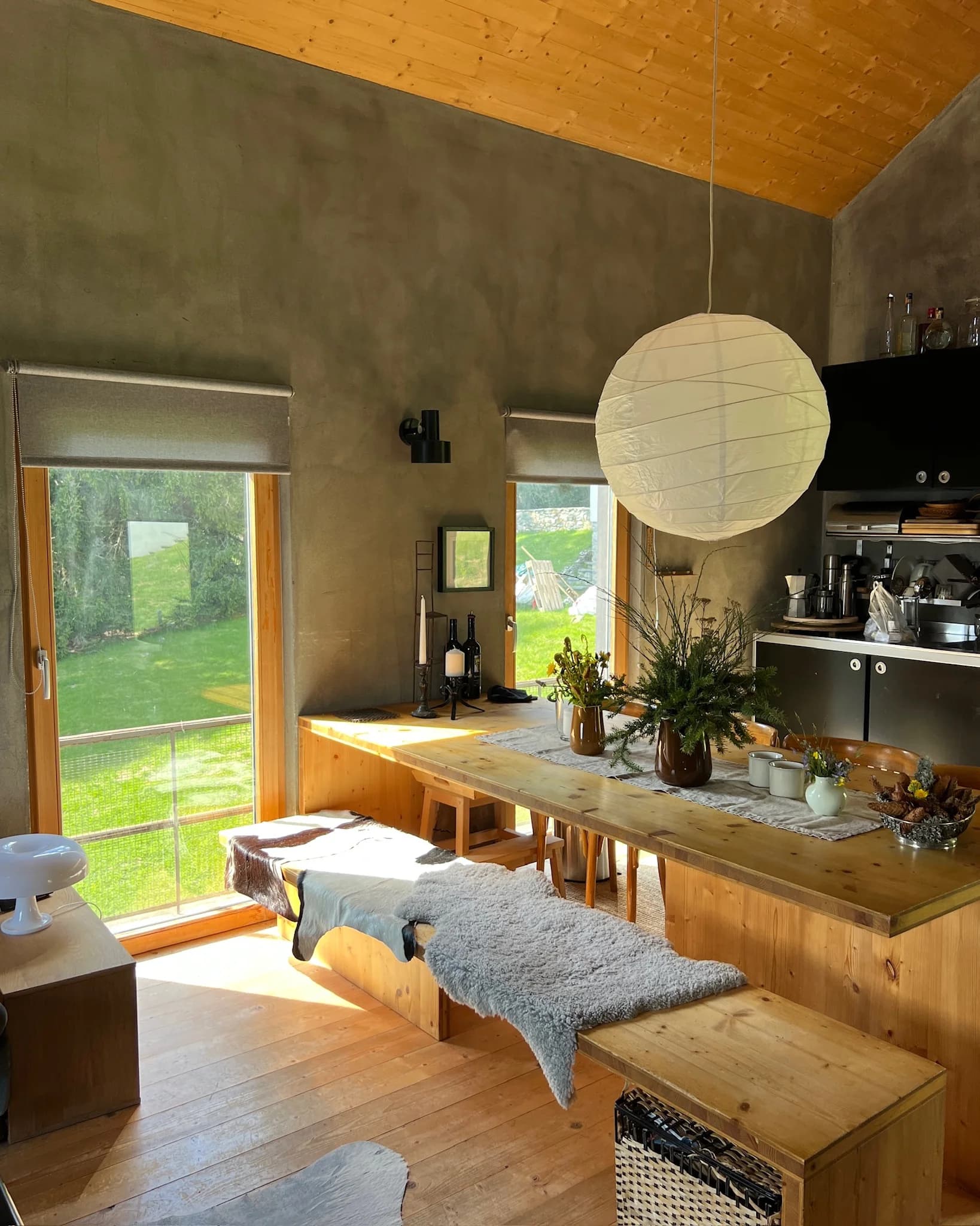 Sunlit dining room with long timber table
