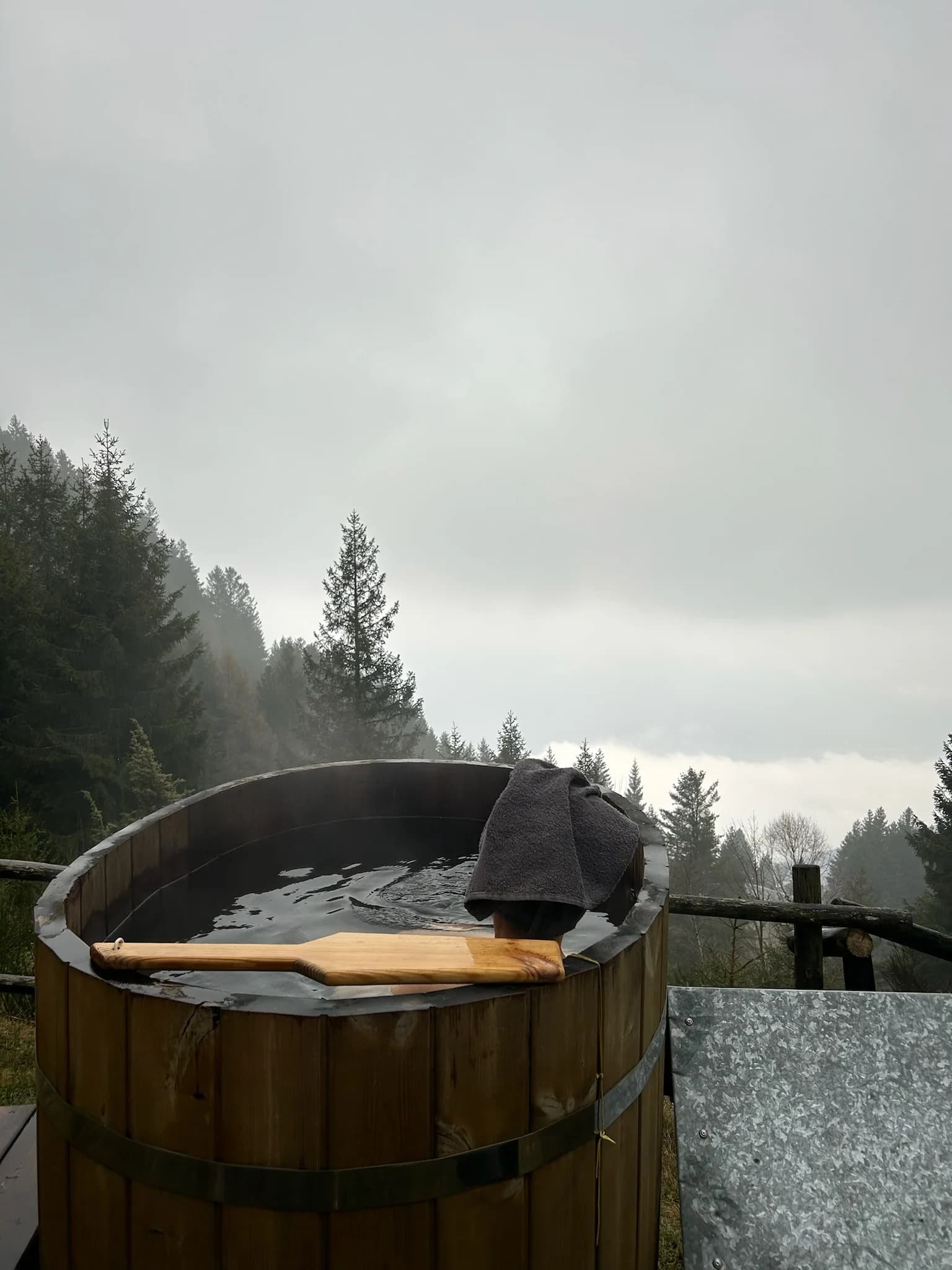 Steaming outdoor hot tub above the clouds