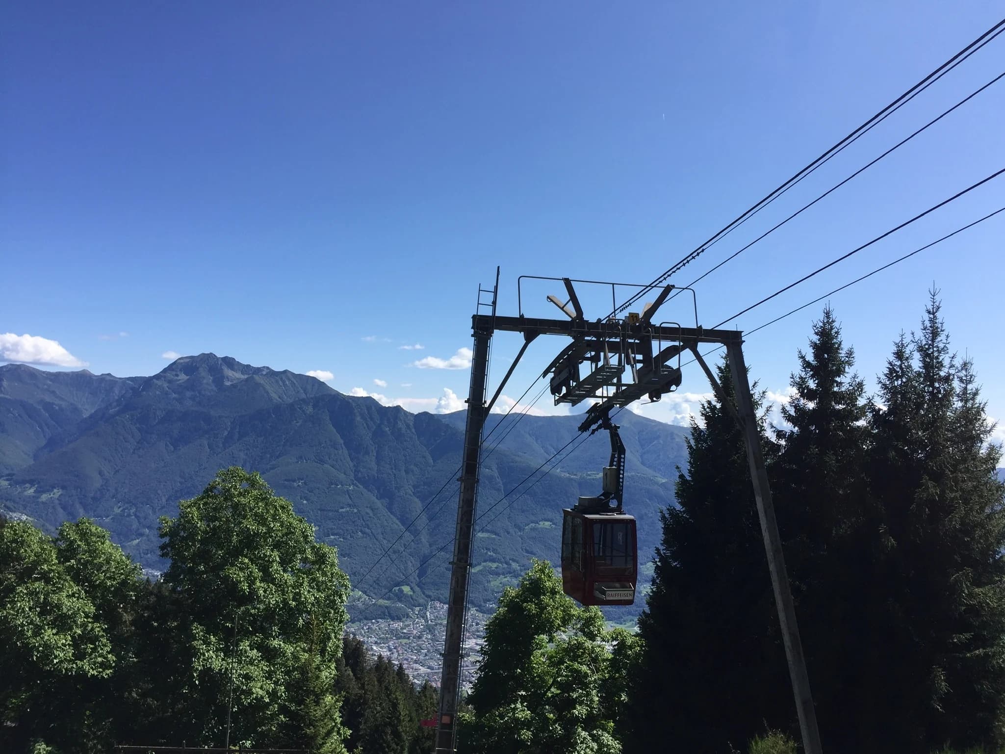 Cable car rising above the mountain valley