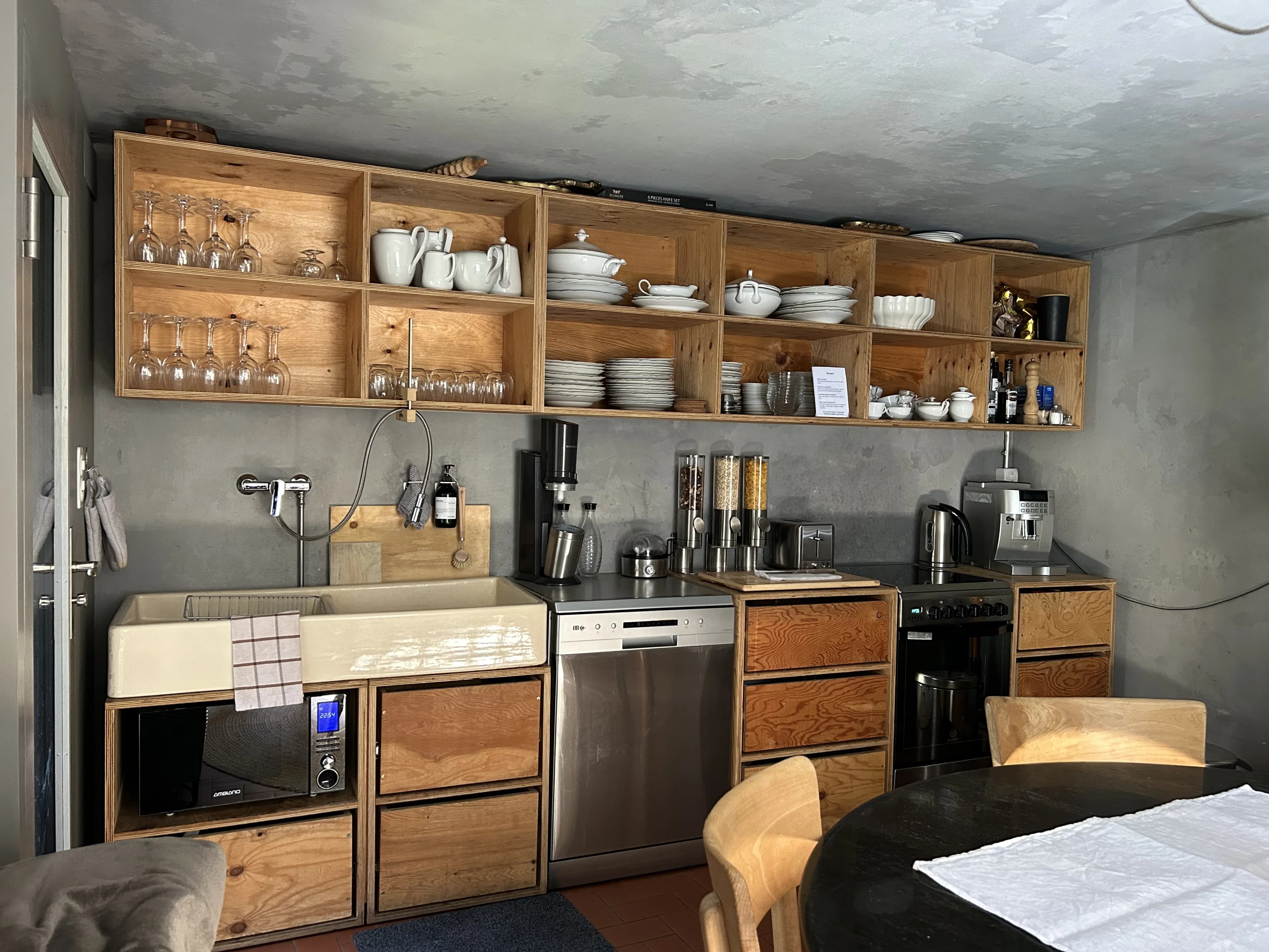 Compact kitchen with open wooden shelving