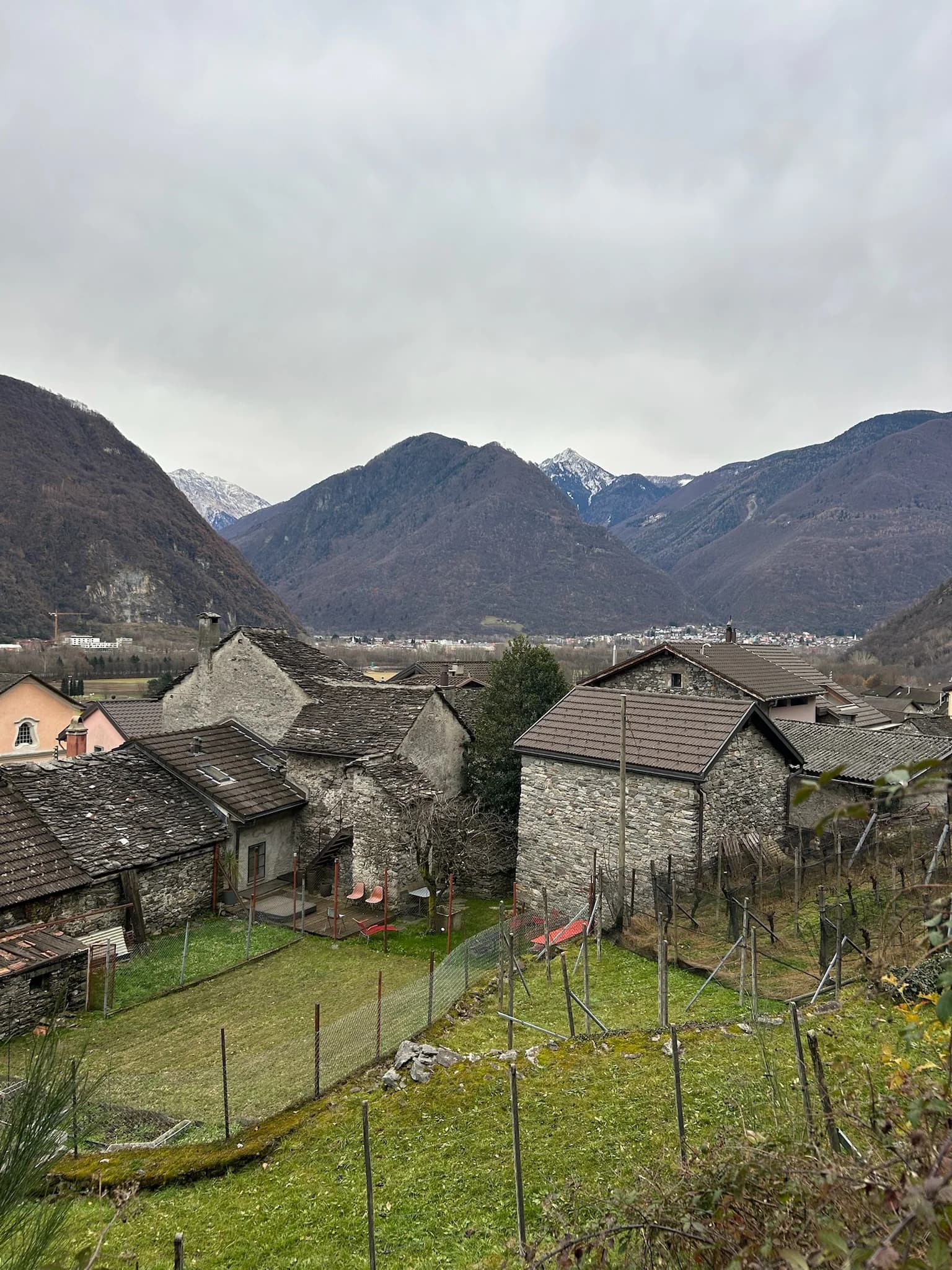 Village rooftops and mountain view from above Gnosca