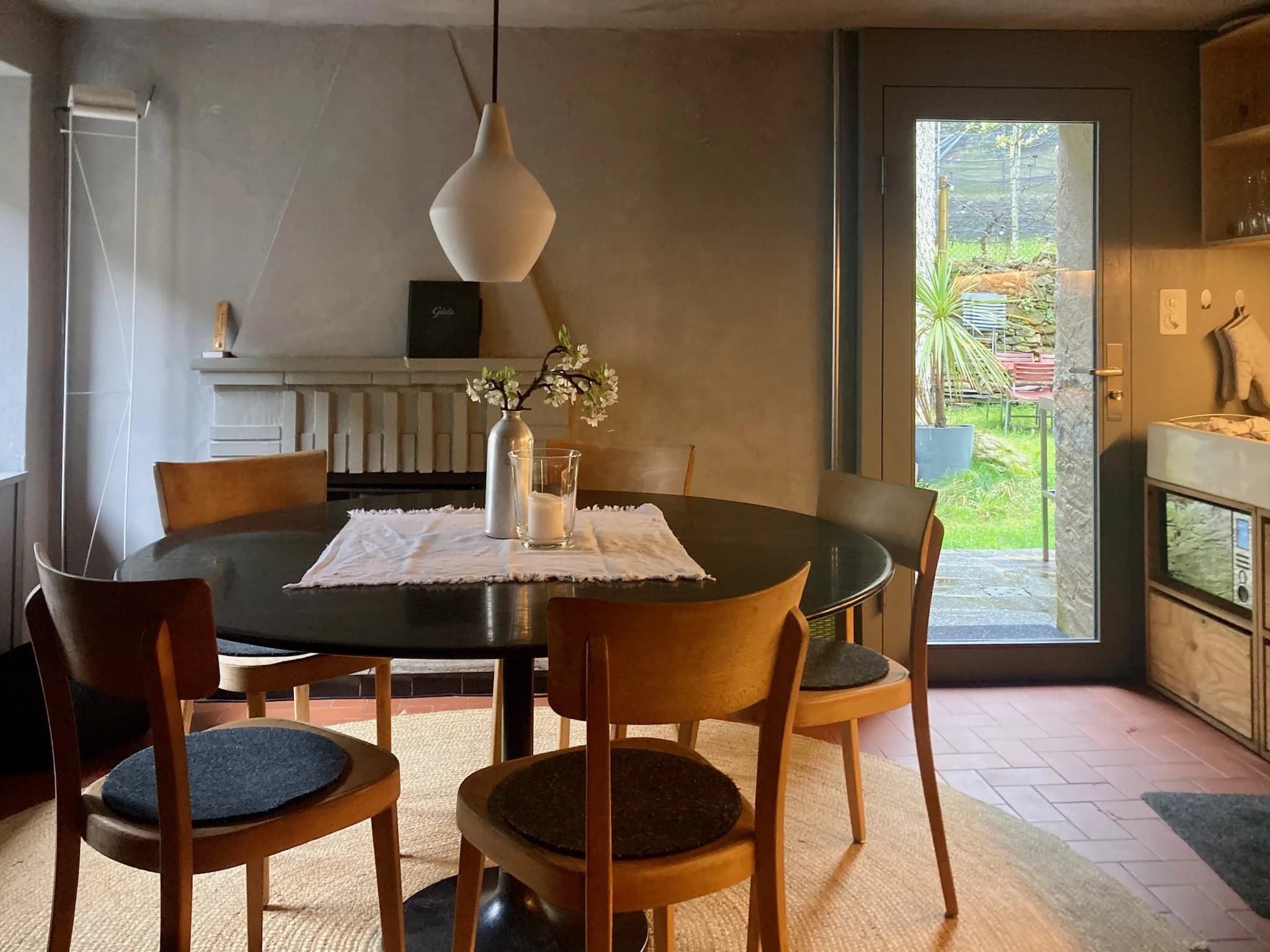 Dining room with round table, fireplace, and garden door