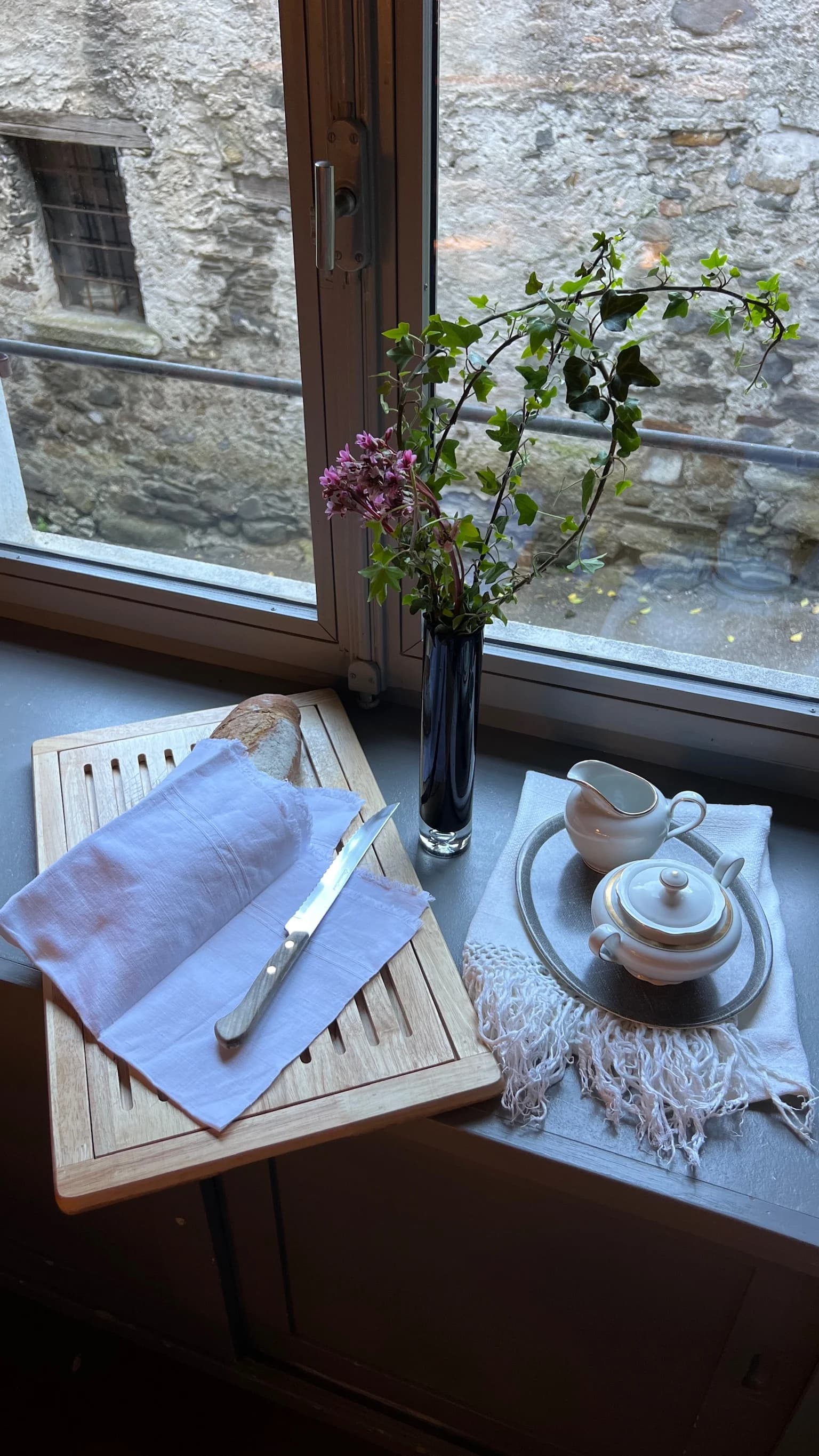 Breakfast tray and flowers by the window