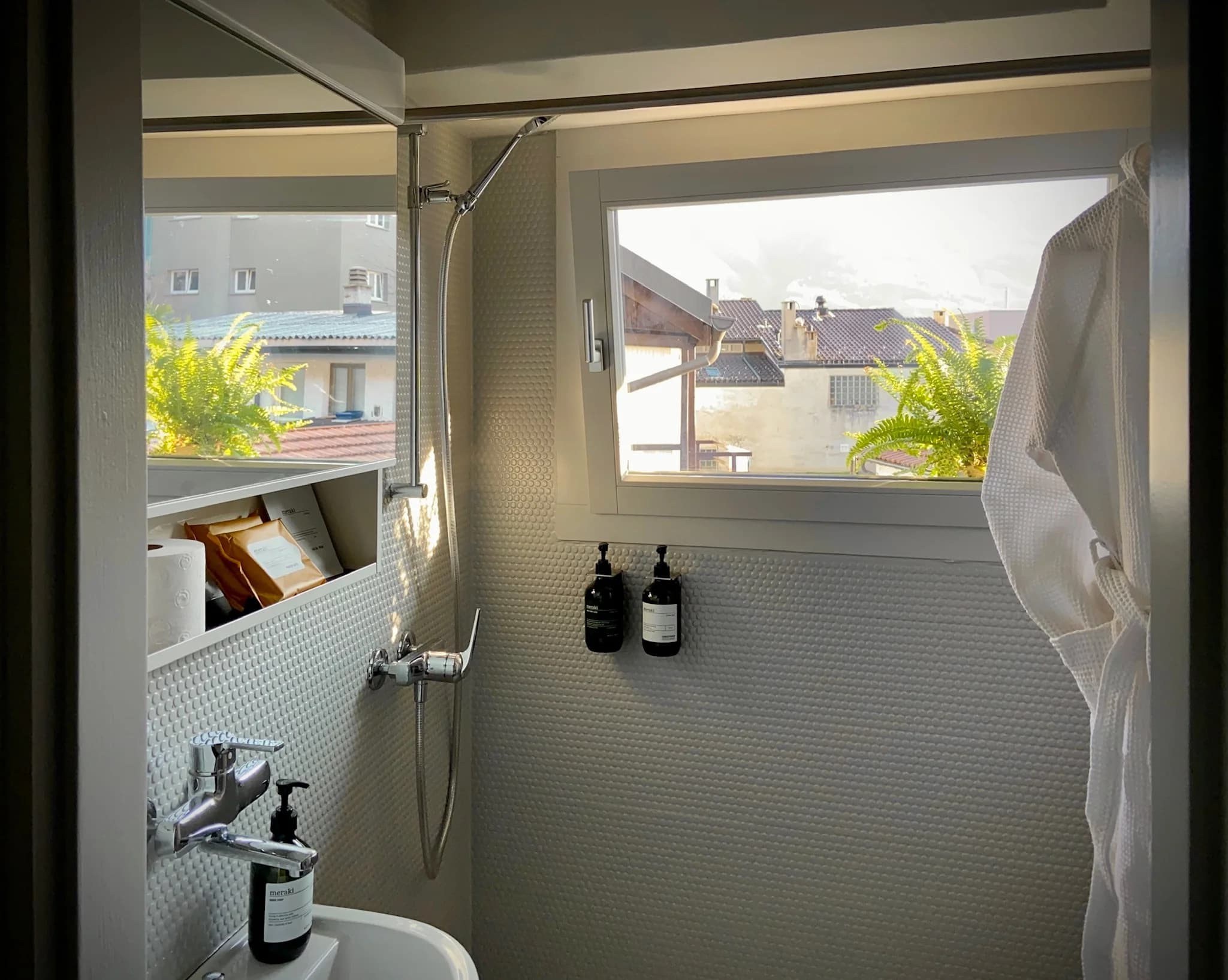 Bathroom shower with robe and village window