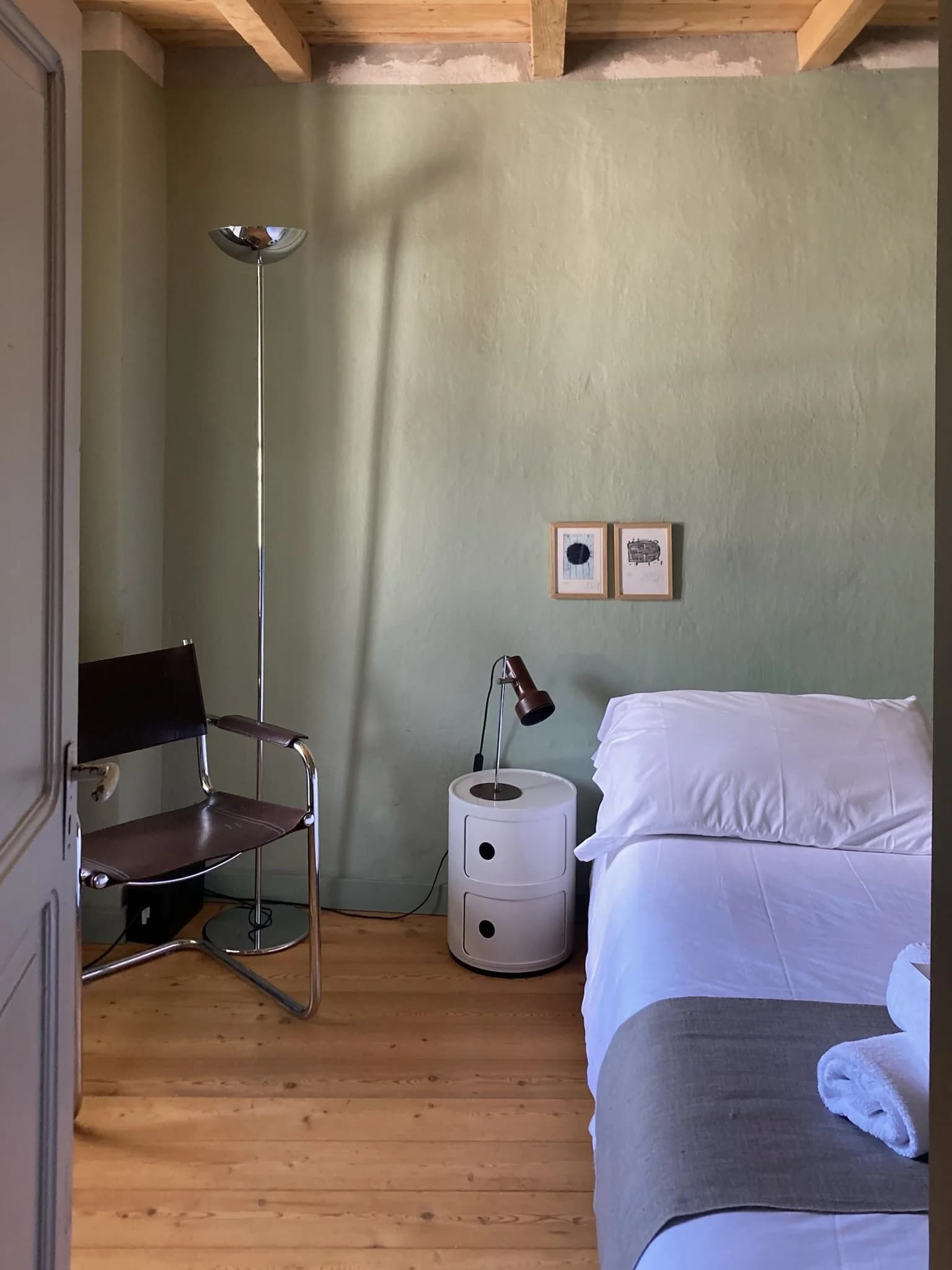 Bedroom with leather chair and pale green walls