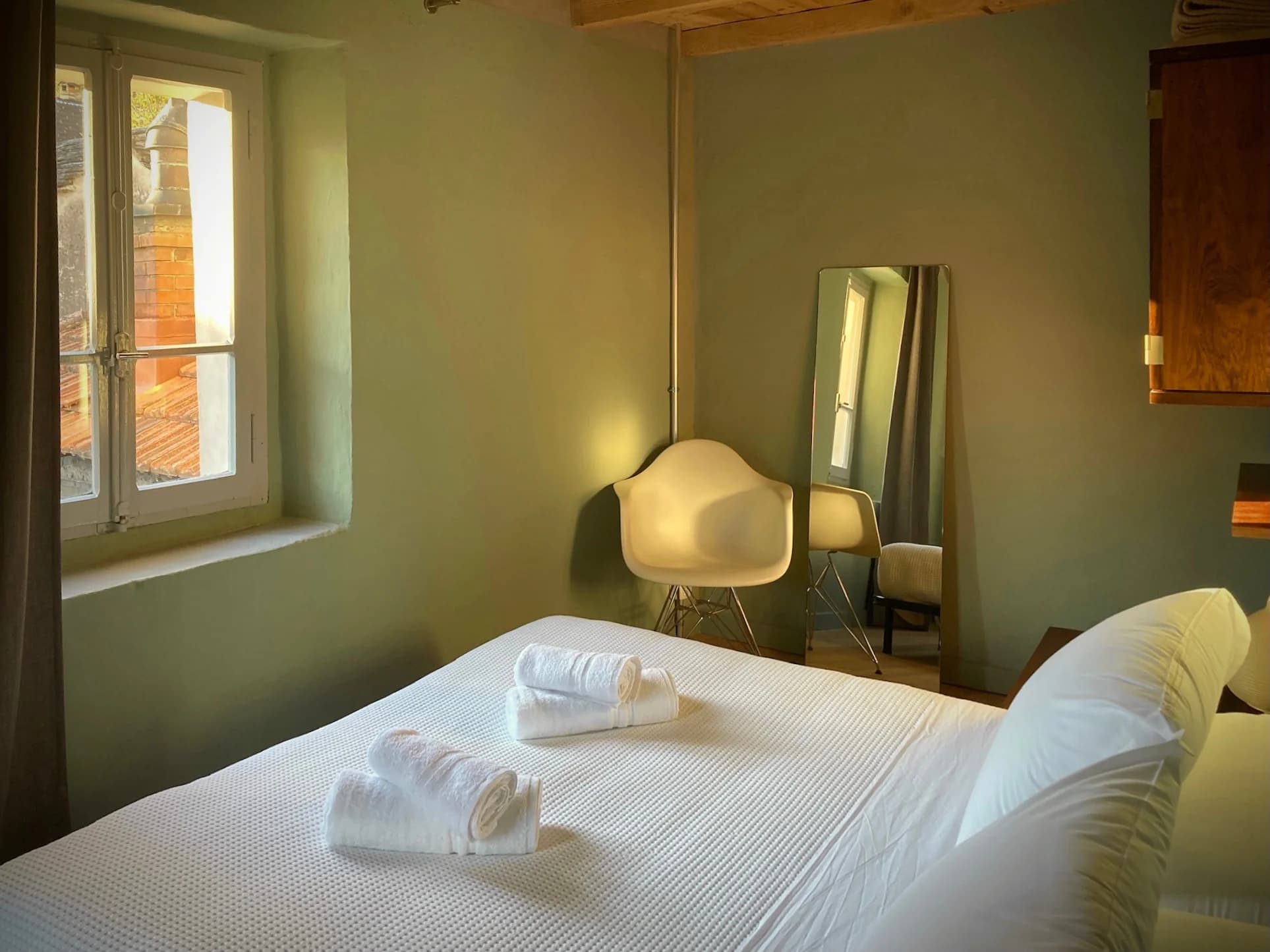Bedroom with white chair and full-length mirror