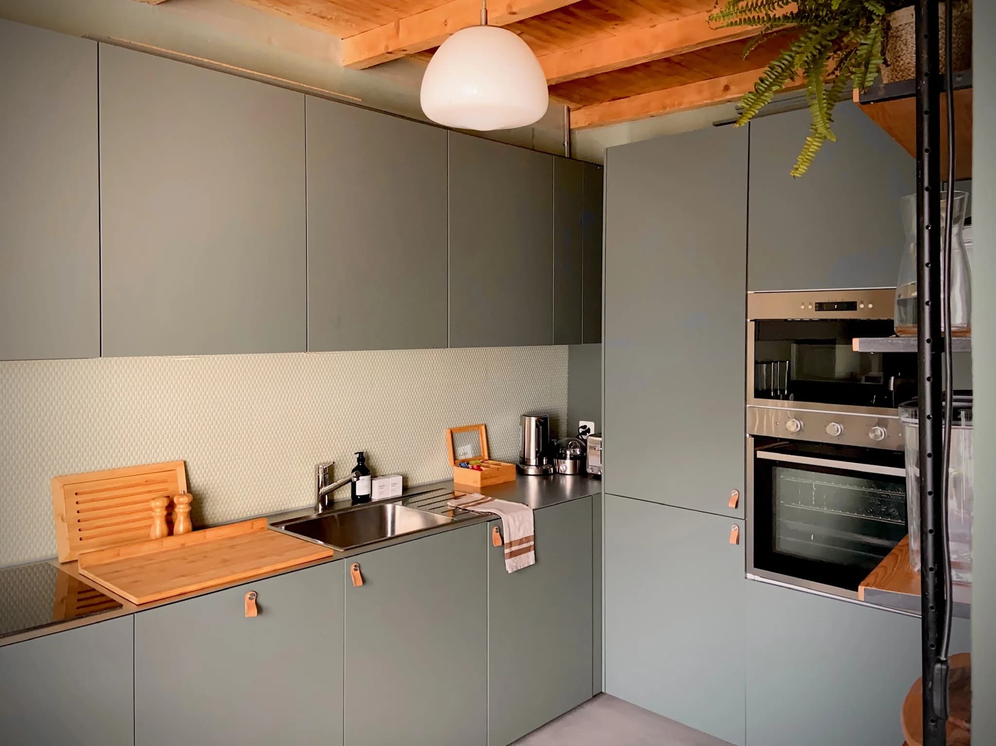 Modern kitchen with muted green cabinetry