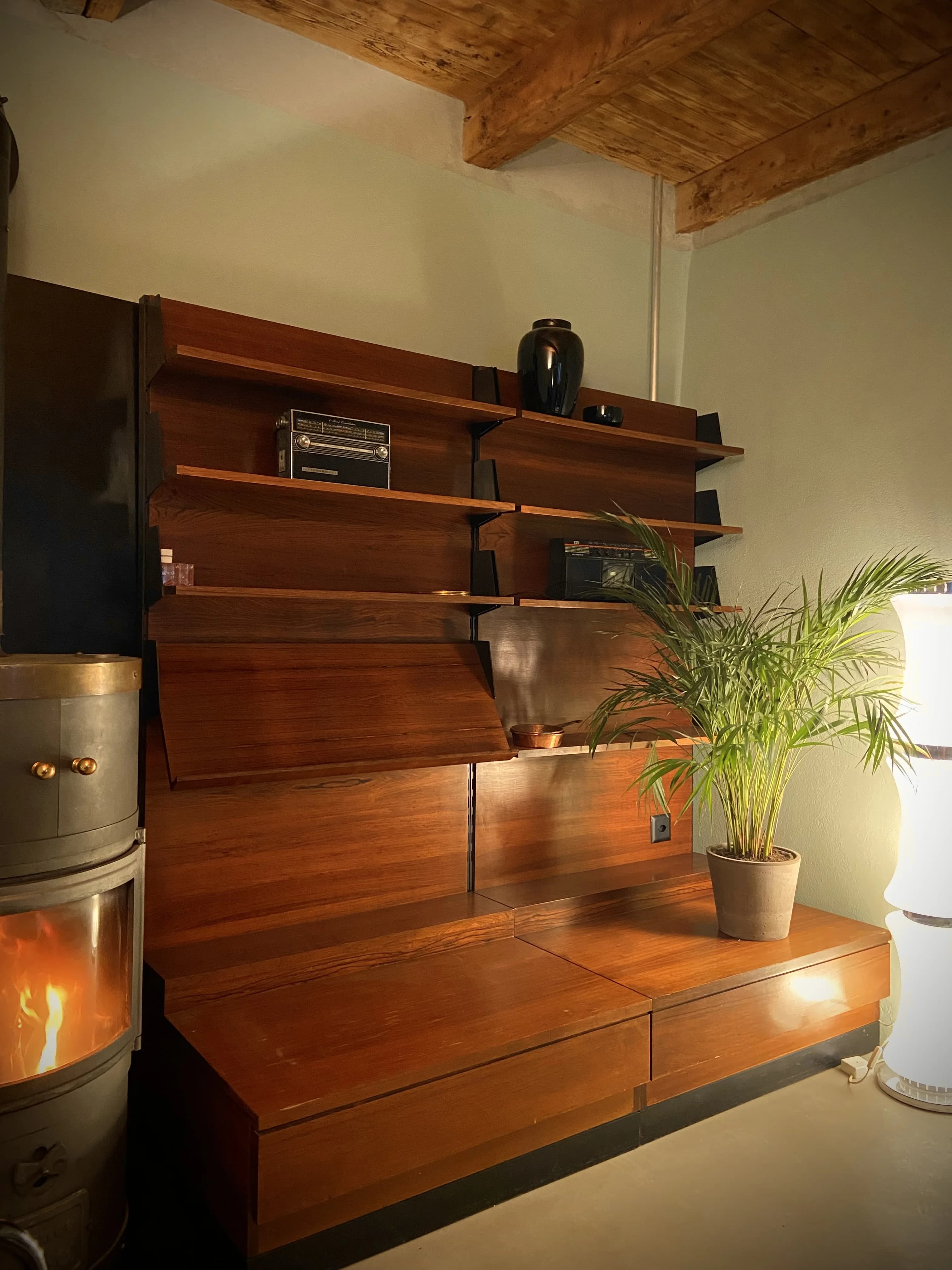 Living area shelving beside the wood stove