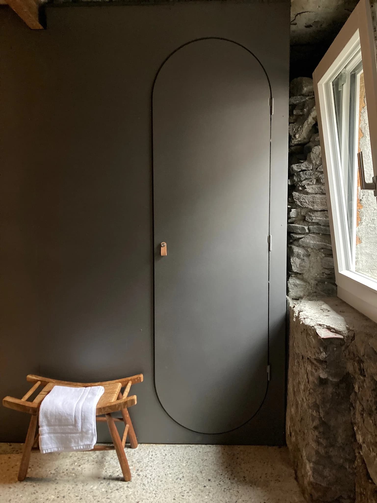 Spa changing alcove with arched dark door
